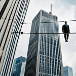 **

A person standing on a tightrope between two skyscrapers labeled "Old Job" and "New Job," with a short-term insurance policy document acting as a safety net below. The sky is dramatic, with a mix of cloudy and sunny patches.

**