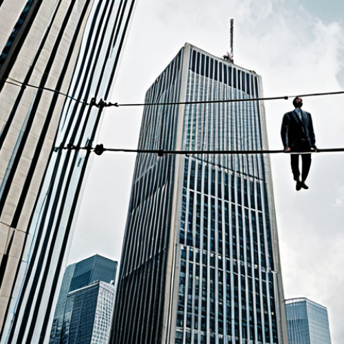 **

A person standing on a tightrope between two skyscrapers labeled "Old Job" and "New Job," with a short-term insurance policy document acting as a safety net below. The sky is dramatic, with a mix of cloudy and sunny patches.

**